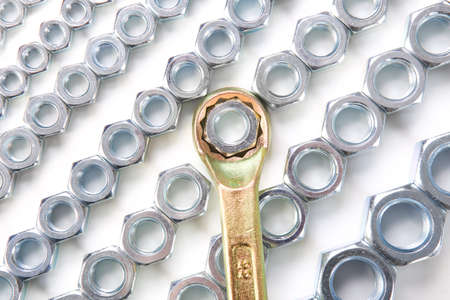 metal brilliant nuts and wrench on white backgroundの写真素材