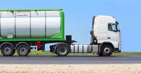 white truck transports freight on the country highwayの写真素材