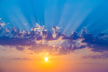 beautiful sunset in the cloudy sky over the seaの写真素材