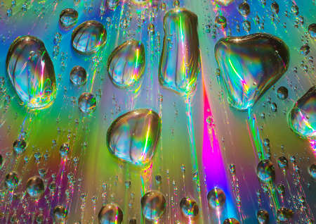 water drops on a color iridescent backgroundの写真素材