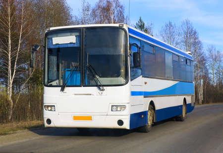 white bus goes on the country highway