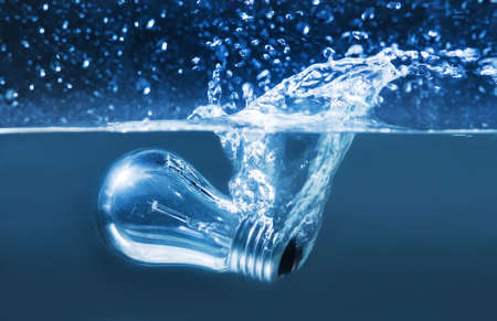 electric bulb in water splashes closeupの写真素材