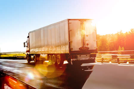 big truck goes on the highway to sunriseの写真素材