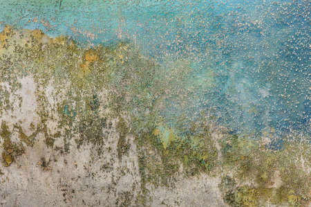 paint which has cracked on an old wall backgroundの写真素材
