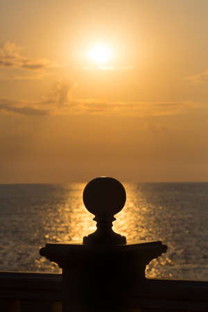 protection support with sphere against sea sunsetの写真素材