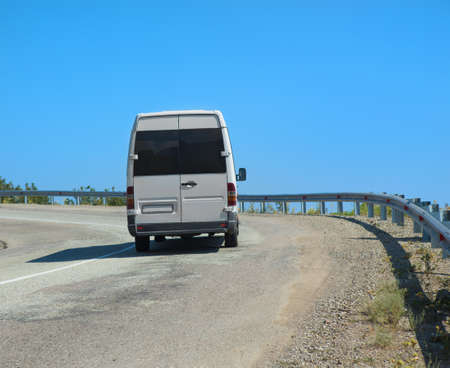minibus goes on mountain road in summer