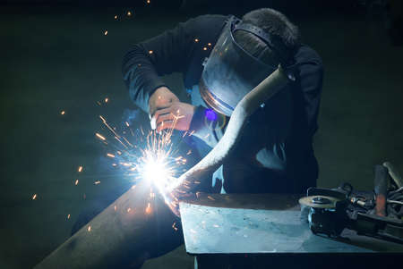 welder in mask welds metal details
