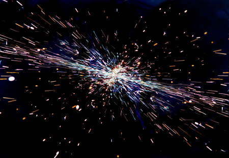 bright sparks of metal against dark backgroundの写真素材