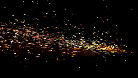 bright sparks of metal against dark background