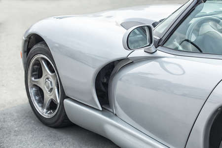 modern silvery sports car on roadの写真素材