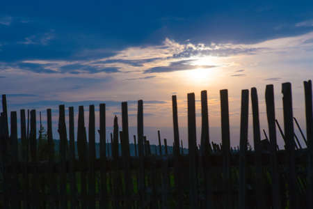 Beautiful sunset and fence in the foregroundの写真素材