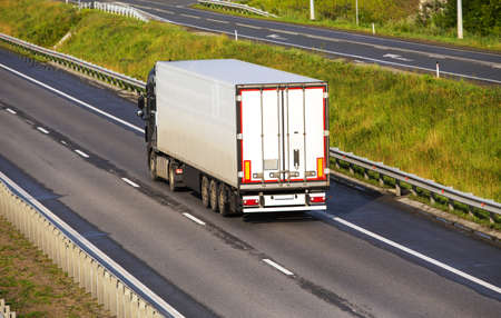 big powerful truck moves on highwayの写真素材