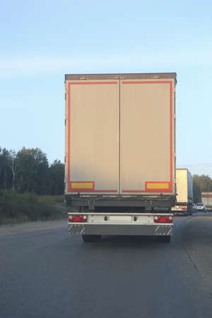 escort of trucks moves on mountain road