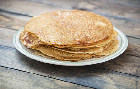 tasty pancakes in plate on tableの写真素材