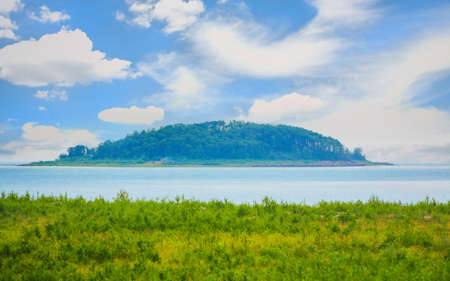 island overgrown with trees in center of lakeの写真素材