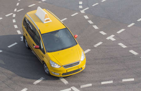 yellow taxi moves on the city streetの写真素材