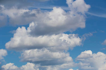 blue sky with clouds closing the sun