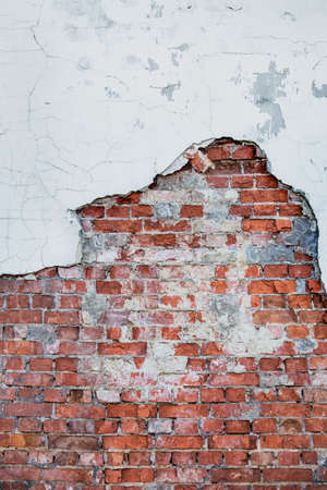 old brick wall from the plaster remainsの写真素材