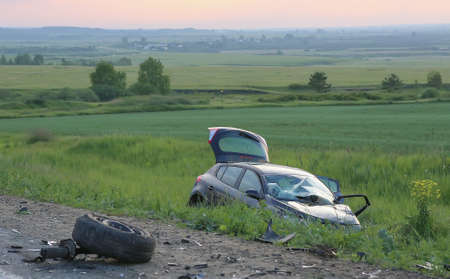 broken by car after accident in field at roadの写真素材
