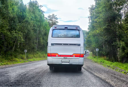 big tourist bus goes on  city streetの写真素材
