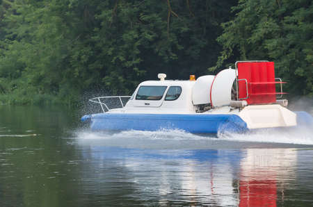 boat with propeller moves down river in summerの写真素材