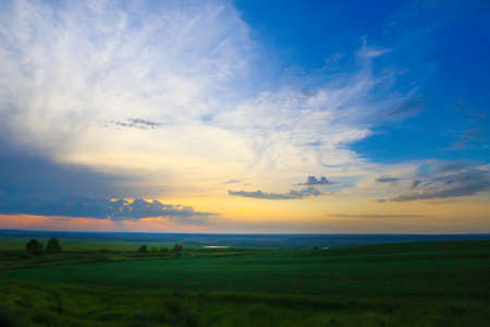 beautiful bright sunset in cloudy skyの写真素材