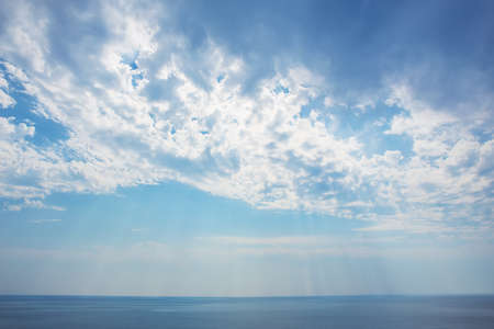 beautiful sunset in the cloudy sky over the seaの写真素材