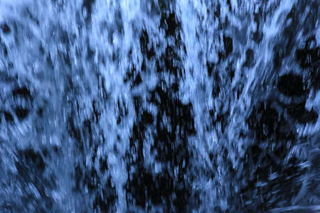 stream of pure water on black background closeupの写真素材