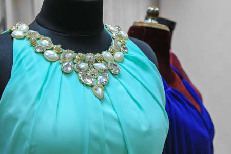 Women's evening dresses on mannequins in a shop closeup