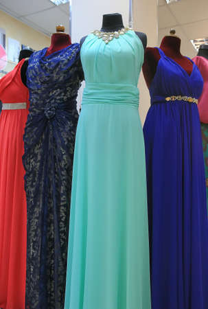 Women's evening dresses on mannequins in a shop closeupの写真素材