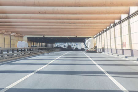 cars leaving tunnel in downtown in sunny dayの写真素材