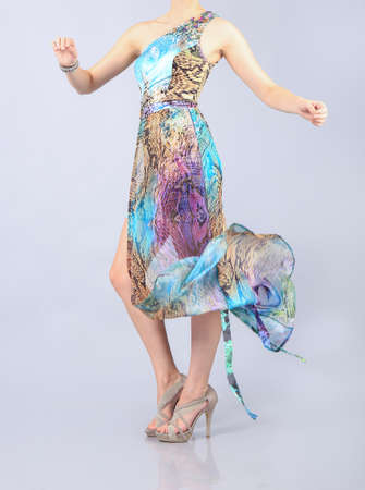 Beautiful long multi colour dress girl in studioの写真素材