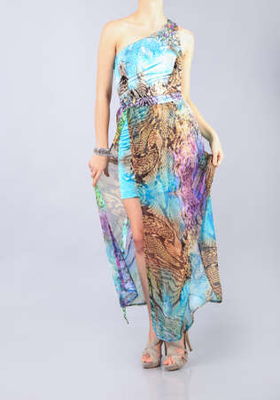 Beautiful long multi colour dress girl in studioの写真素材