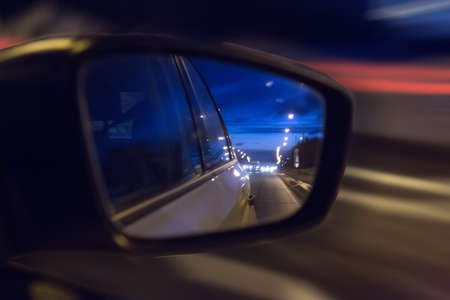 Road reflected in side mirror of carの写真素材