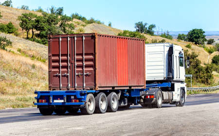 trailer transports container on highway in countryの写真素材