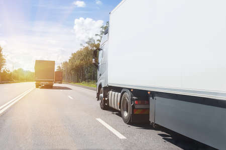 truck goes on the highway to sunriseの写真素材