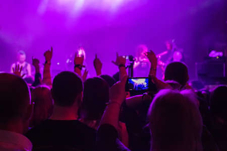 dancing audience at concert at nightclub