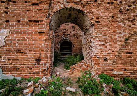 Arched entrance to the old destroyed brick buildingの写真素材