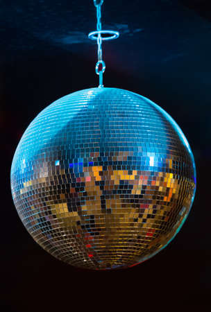 Mirror rotating sphere under the ceiling in a nightclub