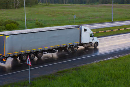 Big powerful truck moves on highway