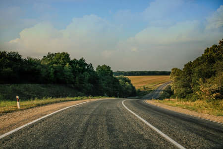 meandering country road and a beautiful landscapeの写真素材