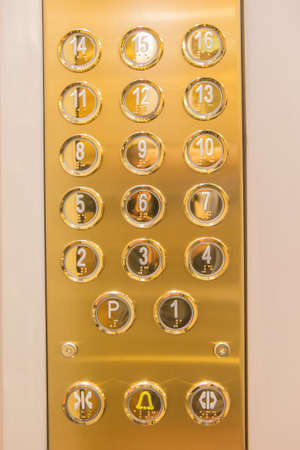 Gilded buttons for selecting floors in the elevator