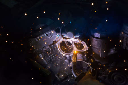 Welding work on a car engine close-up
