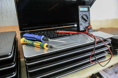 Laptops, screwdrivers, instrument testing and repairの写真素材