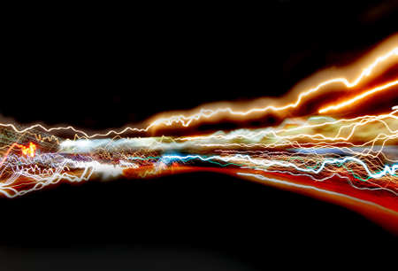 Abstract colored curved lines of light on a black background