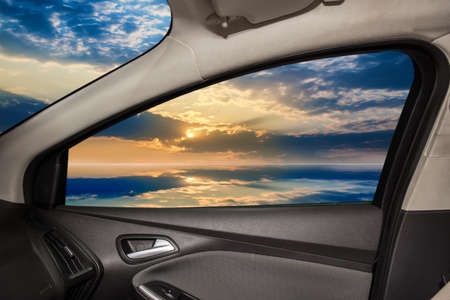 Beautiful clouds and water surface from car windowの写真素材