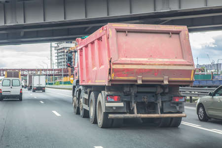 big dump truck goes in the evening on highwayの写真素材