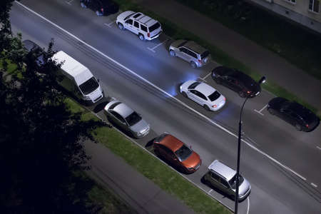 Night street in the city with parked cars
