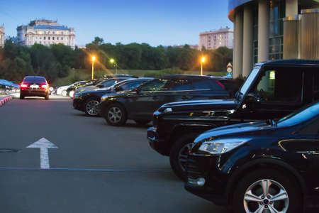Cars in the parking lot in the evening in the city center