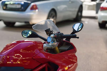 Motorcycle and cars at night in the parking lotの写真素材